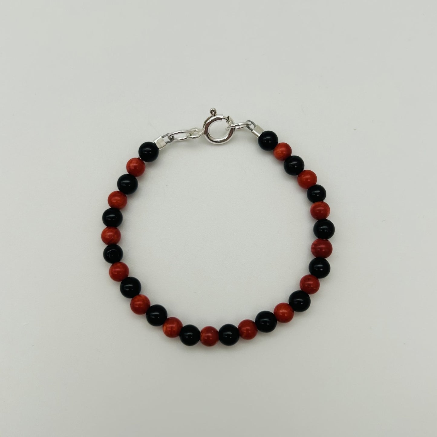 CH941BL Red Dyed Bamboo coral and Onyx Bracelet 4"
