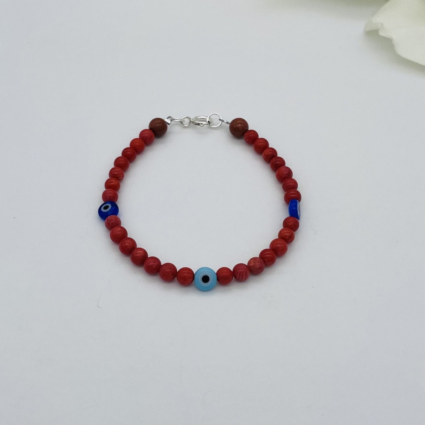 ST1762BL Red Dyed Bamboo Coral Blue Eyes Bracelet 7"